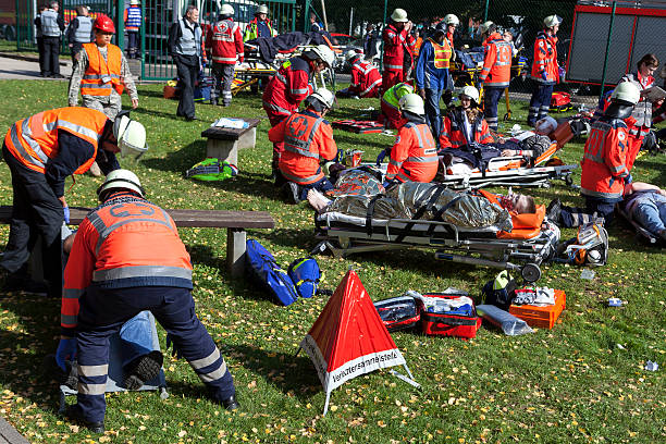Disaster management exercise, mass-casualty incident Wiesbaden, Germany - September 28, 2013: Members of German rescue services are taking care of many seriously injured persons at casualty collection point (Verletztensammelstelle) during a large anti-terrorism and disaster management exercise with German and US Special Forces and emergency services. The displayed injuries and victims are NOT real, approximately 75 actors portraying wounded or injured people which have been made up by a special team of makeup artists triage stock pictures, royalty-free photos & images