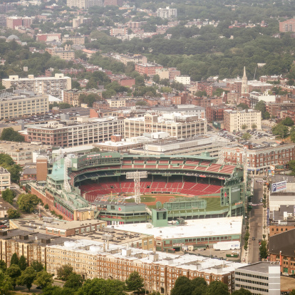 Boston, Massachusetts, USA - July 19, 2011: Aerial view of Boston with Fenway Park stadium. The FenWay Stadium is the official stadium of the Boston Red Sox baseball team. Cloudy day.