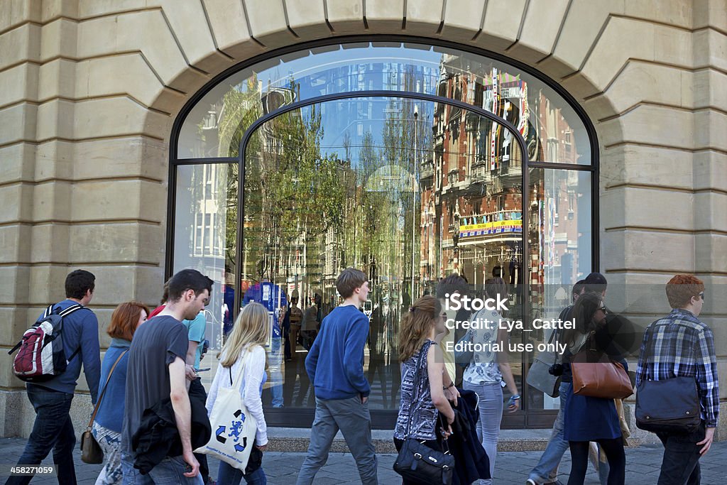 Amsterdam Apple store Amsterdam, the Netherlands - June 4, 2013: People passing the Apple store building at Amsterdam. The Hirsch Building is located at the Leidseplein, opposite the theater and the American Hotel. These buildings are reflected in the Apple store window. Big Tech Stock Photo