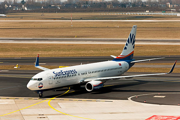 Boeing 737-800 Dusseldorf, Germany - April 1, 2013: The Boeing 737-800 of of the Airline SunExpress starts at the airport in Dusseldorf. SunExpress is a Turkish airline based in Antalya and bases at the airports of Antalya, Istanbul-Sabiha Gak!Aaen and Azmir. Since 8 June 2011 SunExpress operates with Sun Express Germanyis a German subsidiary, which has its own operating license and its own fleet. sunexpress stock pictures, royalty-free photos & images