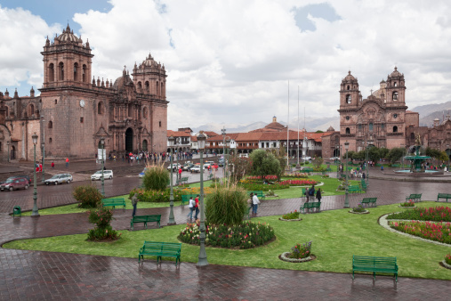 Cuzco, Peru -  September 15, 2011 :   After the rain has passed, afternoon sun and people return to the Plaza de Armas.