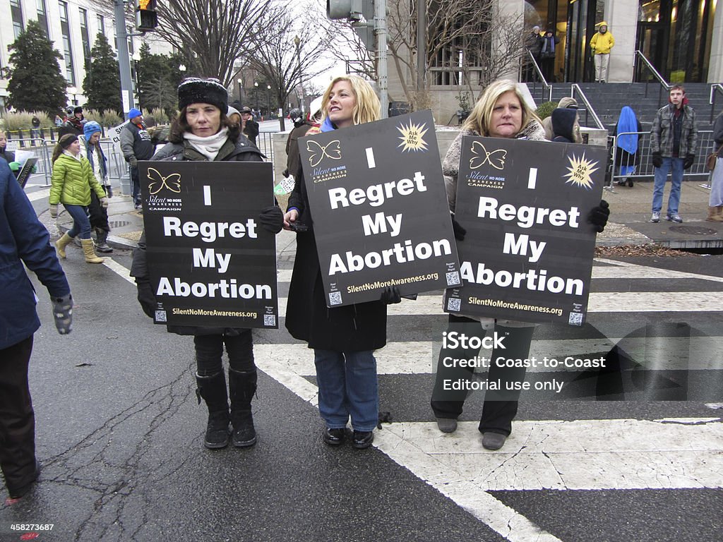 Women Who Regret Abortion Washington D.C., USA-January 25, 2013: These women hold signs that tell people they regret their abortions near the Supreme Court in order to turn over the Supreme Court decision Roe Versus Wade on the 40th anniversary date of that decision.  This protest occurs annually drawing large crowds even though the decision to grant a woman the right to choose to have an abortion was made long ago. Pro-Life Stock Photo