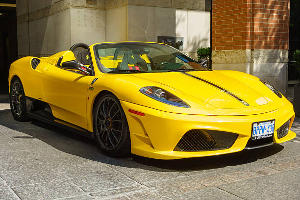 Ferrari 430 Scuderia Spider 16M Toronto, Canada - August 18, 2013: Yellow colored Ferrari 430 Scuderia Spider 16M convertible parked on a driveway. 2000 2009 photos stock pictures, royalty-free photos & images