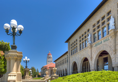 Sanford, United States - July 6, 2013: To the backdrop of Hoover Tower, historic Jordan Hall on the campus of Stanford University.