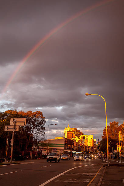 Rainbow over busy city street with dramatic clouds Bondi Junction, Sydney, NSW, Australia - June 28, 2009: Rainbow after rain over busy Bondi Junction road. Sunset with dramatic skies. bondi junction stock pictures, royalty-free photos & images