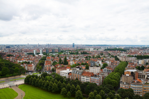 Brussels, Belgium - July, 21st 2012: Aerial view of Brussels' western areas from basilica Koekelberg. Below are some trees around church. Cloudy summer sky.