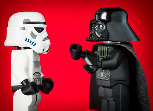 Edinburgh, UK - November 19, 2012: Macro image showing a Lego figure of the Star Wars character Darth Vader with a Lego Stormtrooper soldier character.