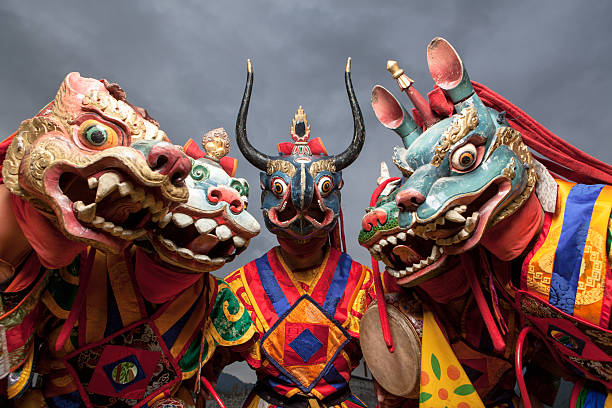 Masked bhutanese dancers in traditional costumes stock photo