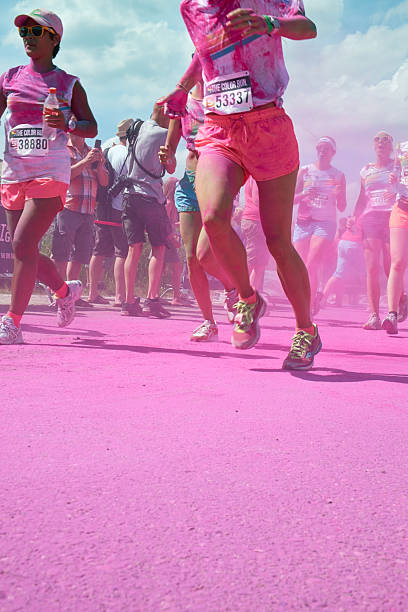 Utrecht, The Netherlands - August 4, 2013: Runners are showered with colored powder at the pink color station during the color run in Utrecht, the Netherlands.