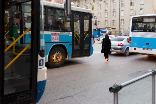 Ankara, Turkey - January 21, 2013: Woman run through the public buses and across the \