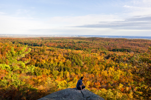 Gatineau, Canada - October 5, 2013: unidentified person looking at the national park in autumn in Canada