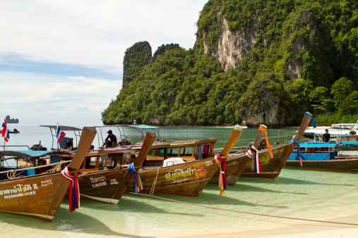 Krabi, Thailand - October 24, 2012: Thai longboatThe long-tail boat,is a type of boat that isnative to South East Asia, which uses a common car or truck engineas a readily available and maintainable power plant.Koh Hong island is situated in the Andaman sea one hour north of Krabi, It has one beach and is enclosed by steep cliffs. The beach has fine white sand and the lagoon has lots of beautiful coral and tropical fish swimming in it.The Koh Hong island give a truly secluded feel.