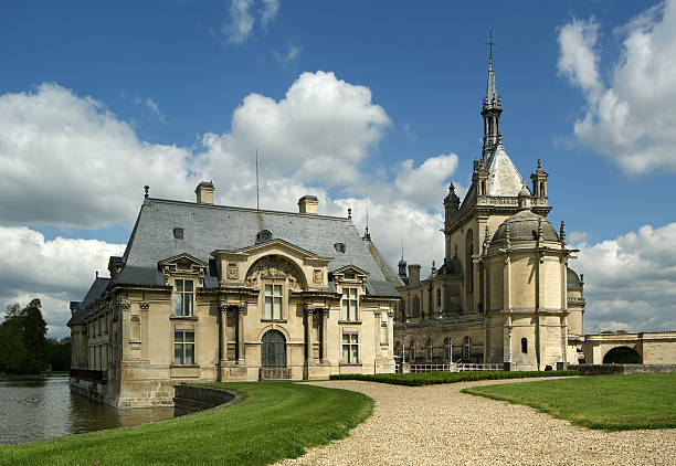 Chantilly, France- May 12, 2012: Chateau de Chantilly ( Chantilly Castle ), located in the town of Chantilly, France. The Chateau consists of two buildings: Petit Chateau (built in 1560) and Grand Chateau (was destroyed during the French Revolution and rebuilt in 1870). The Chateau is Musee Conde - one of the best art galleries in France