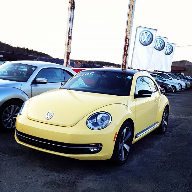 Saint John, New Brunswick, Canada - April 28, 2012: A 2012 Volkswagen New Beetle is parked on a car dealership lot.  Front and side profile of vehicle with \