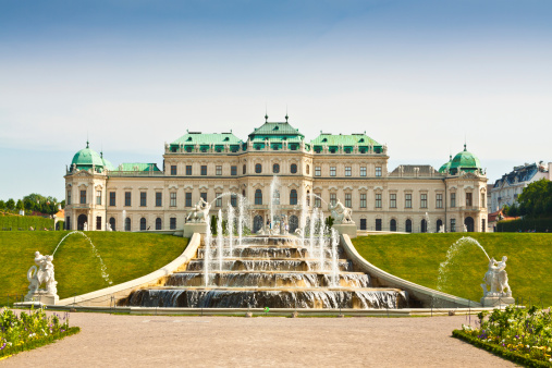 Vienna, Austria - June 18, 2013: The Belvedere Palace. It is a historic building complex consisting of two Baroque palaces (the Upper and Lower Belvedere) - the image shows the upper Belvedere seen from the garden. Tourists are walking around.