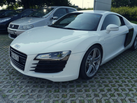 Lausanne, Switzerland - July 22, 2013: An Audi R8 side view. Vehicle is parked outside in a supermaket parking lot. The Audi R8 is a mid-engined sports car that features a 4.2L V8 engine producing 420 HP.
