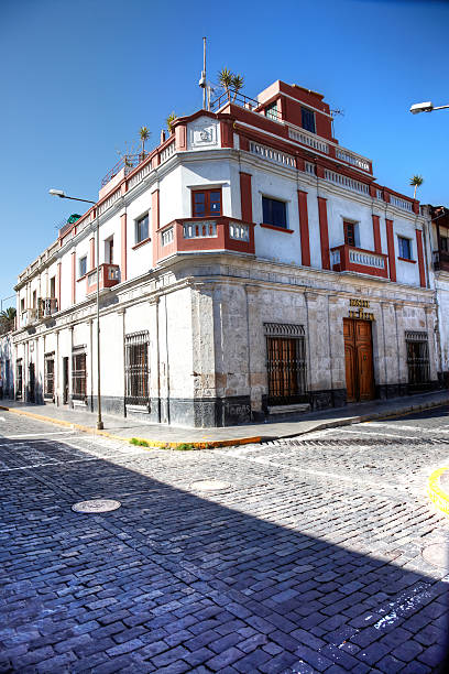 Arequipa, Peru - May 25, 2013: Peruvian arcitecture building on corner of cobblestoned street in the city of Arequipa.