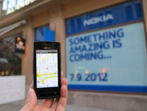 Helsinki, Finland-July 12,2012: Nokia shop will be open on September 7,2012. A man hold model of 500 nokia's mobile phone and which is located the shop in Helsininki, Finland.