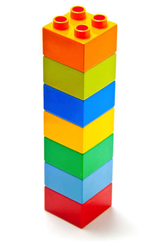 Albuquerque, USA - October 14, 2012: A stuck of old, yellow, green, orange, blue, and red, bricks on white background Lego interlocking blocks are one of the most popular construction toys ever invented.  Lego blocks are produced in many variations and for a wide range of themes. All individual pieces remains compatible with existing pieces promoting children innovation and allowing endless combinatios of building opportunities.