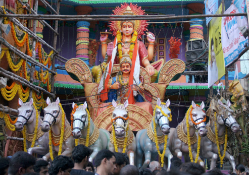 Hyderabad,Ap,India-September 28,2012:Hindu devotees pray  Surya bhagavan at 58 feet high Lord Ganesha idol,one of the biggest idols made annually, at Khairatabad, during Ganesha chathurthi festival.