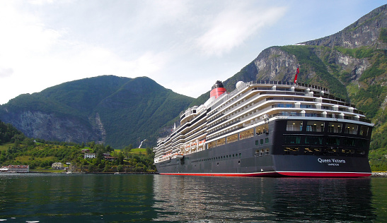 Flam, Norway - August 6, 2012: MS Queen Victoria moored in the town of Flam in the Aurerlandsfjord in Norway. The MS Queen victoria is a cruise ship operated by the Cunard Line