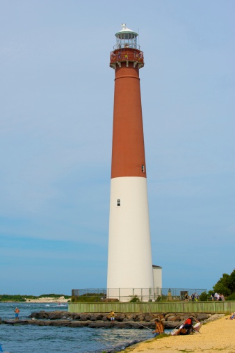 Barnegat,New Jersey,USA-august 17,2013:People enjoying a summer day at the New Jersey shore with Barnegat lighthouse in background.