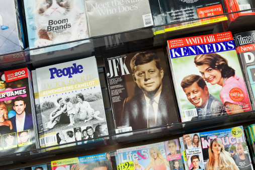 New York City, USA - October 1, 2013: Stack of popular magazines on the outside of the street side newsstand on Broadway Upper West. Vanity Fair, People and JFK with special editions of The Kennedy's 50 years later can be seen.