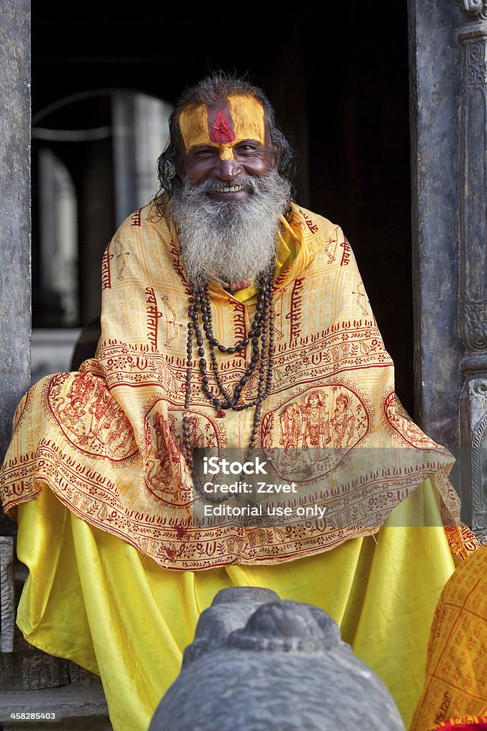 Sadhu - Holy Man Kathmandu, Nepal - November 13, 2009: Sadhu seeking alms in front of a temple in Pashupatinath. Adult Stock Photo