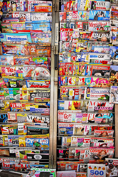 Media and magazine news stand. Madrid, Spain- May 30, 2013: Partial image of a traditional news-stand also known as "Kiosco"'  displaying a large variety of local and international magazines. newspaper seller stock pictures, royalty-free photos & images