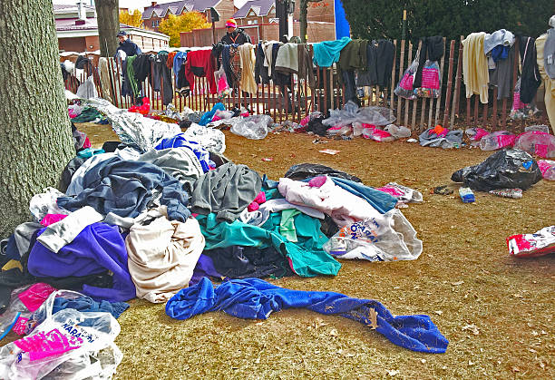 New Yourk Marathon, November, 3, 2013: charity donations New York City, USA - November 3, 2013: New Yourk Marathon charity donations. It was a cold and windy day when New York Marathon started, and most runners waited for a start in warm clothing. Just before the start they took off their warm clothes and left them at the corrals. All this clothes will be sorted and donated for charity. new york marathon photos stock pictures, royalty-free photos & images