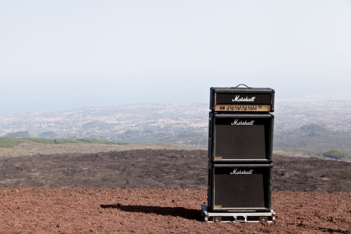 Sicily, Italy- May, 20th 2013 A very old iconic Marshall amplifier at Volcano Etna (3,3350 m), Sicily, Italy. This amplifier is at the mountain of Etna, Sicily because there was a band who gave a open air concert at the mountain and also there was a video shooting. The Marshall amplifier was first manufactured in England in 1962. The company and it's products is still in business today. Their guitar amplifiers are among the most recognized brands in popular music