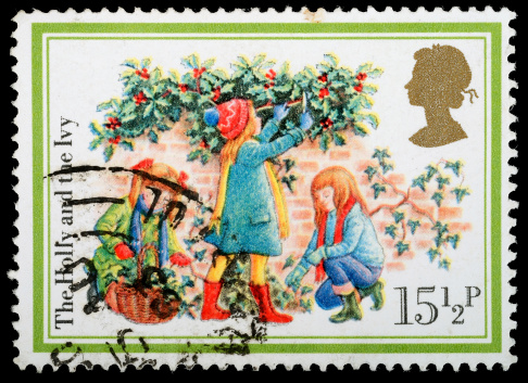 Exeter, United Kingdom - October 29, 2011: A British Used Christmas Postage Stamp showing the Children and the Christmas Carol The Holly and the Ivy, printed and issued in 1982