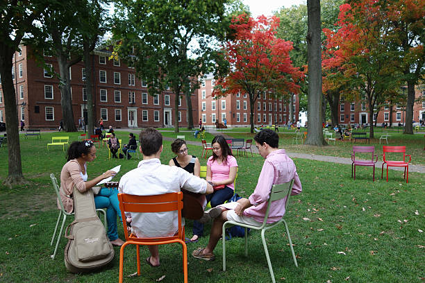Group of young men and women having discussion at Harvard stock photo