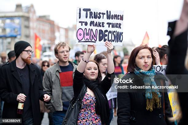 Young Woman Holds Hand Made Poster About Women Decisions Stock Photo - Download Image Now