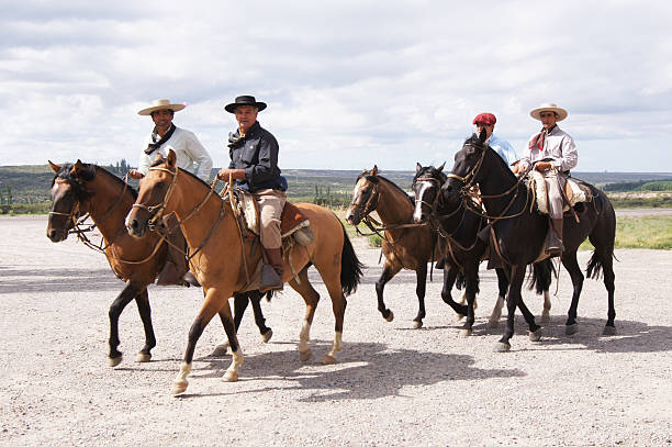 Argentinian gauchos Tupungato Department, Argentina - February 25, 2012: Four men riding horses near the highway on TupungatoA's region, near Mendoza, the Argentinian wine land. gaucho stock pictures, royalty-free photos & images