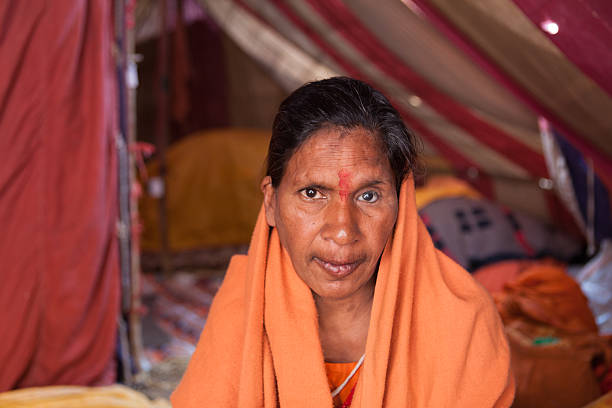 Female sadhu in shelter camp at Kumbh Mela stock photo