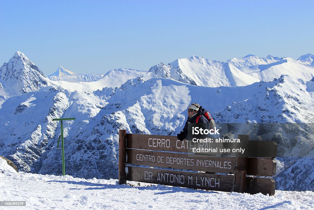 Man in front of Lynch Refuge - Andes * Patagonia San Carlos de Bariloche, Cerro Catedral, Argentina - July 18, 2013: Man in front of Lynch Refuge - Andes * PatagoniaVery beautiful scene at  CERRO CATEDRAL - Patagonia - ArgentinaThe Refugio Lynch or Lynch Refuge is a little building located at the top of the CERRO CATEDRAL mountain and was built on 1943.CERRO CATEDRAL is a mountain located near San Carlos de Bariloche, within Nahuel Huapi National Park - Argentina. This mountain has one of the main SKI Resorts of South America, with 600 hectares of skiable surface divided into 53 well sign-posted trails of various difficulties, which reach 2.000 meters over sea level. Adult Stock Photo