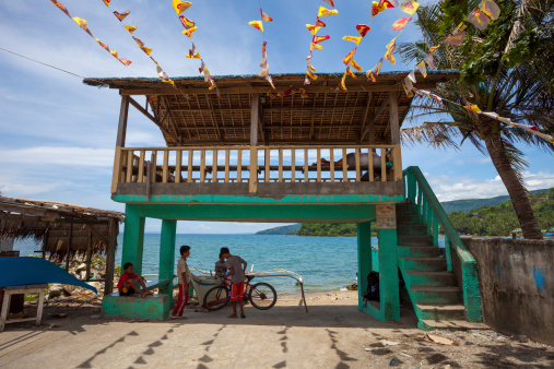 Sabang, Philippines - May 17, 2012: Gateway to the beach and a temporary boat harbour at Puerto Gallera near the Sabang town in the Philippines. Some people can be seen in the image.