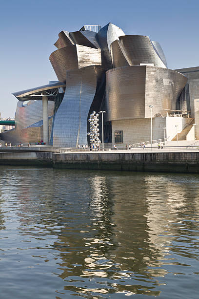 Guggenheim Museum Bilbao Bilbao, Spain - September 7, 2012: View of the river NerviAn and back of the Guggenheim Museum of Contemporary Art, designed by architect Frank O. Gehry. There are people walking around frank gehry building stock pictures, royalty-free photos & images