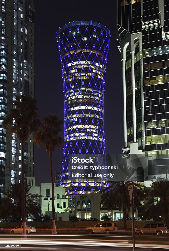 QIPCO Tower in Doha, Qatar Doha, Qatar - January 9, 2012: Blue illuminated QIPCO Office Tower or alias Tornado Tower, in Doha, Qatar, Middle East. The tower is a 200m heigh skyscraper located in the new downtown district Al Dafna, Doha Arabia Stock Photo