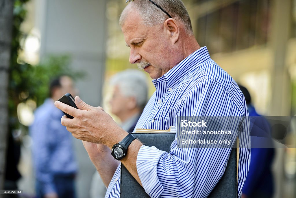 Businessman using his mobile phone on Los Angeles street Los Angeles, USA - May 1, 2013: Businessman using his mobile phone on Los Angeles street Adult Stock Photo