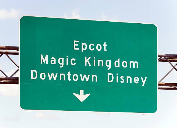 Walt Disney World Attractions Orlando, Florida, USA - April 18, 2013: A highway sign points the way to Walt Disney World attractions. Located in Lake Buena Vista, Florida, The Walt Disney World Resort is the world's most visited entertainment resort. disney world stock pictures, royalty-free photos & images