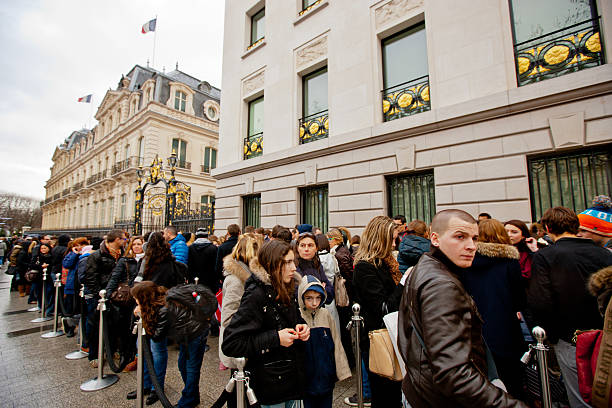 People waiting in line near Abercrombie & Fitch Shop, Paris Paris, France - December 27, 2012: People waiting in line to enter the  Abercrombie & Fitch Shop, located on Champs-ElysAes, Paris abercrombie fitch stock pictures, royalty-free photos & images