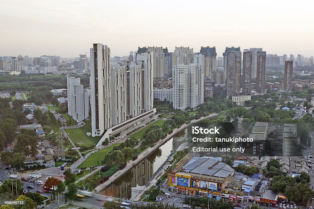 Contemporary Apartments in Beijing Beijing, China - August 23, 2013: sunset over the contemporary architecture deisgn of the residential complex called Antusheng Garden located in Hongxia Road, Chaoyang district. In foreground vehicles riding on Juxianqiao Road. Aerial View Stock Photo