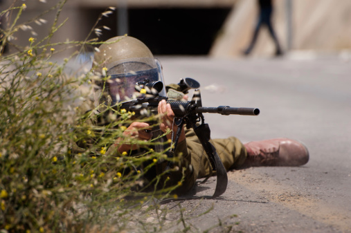 AL KHADER, PALESTINIAN TERRITORY - May 14, 2013: Israeli soldiers target Palestinian youth with rubber-coated steel bullets during clashes near the village of Al Khader, West Bank, May 14, 2013. The protest was in observance of the Nakba, literally, the 