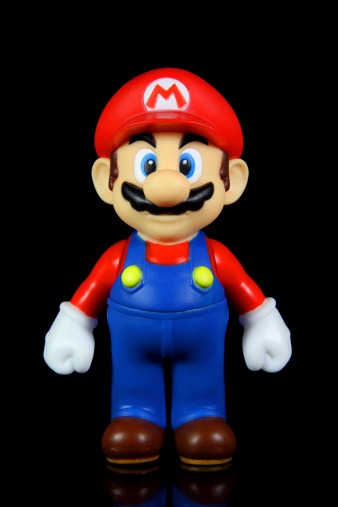 Vancouver, Canada - October 4, 2012:  Mario from the Nintendo Super Mario franchise of games, posed against a black background. The toy is from Banpresto Company.