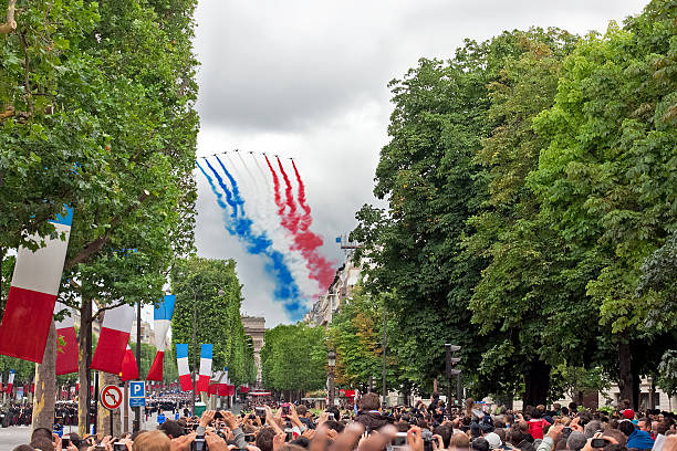 Paris, France - July 14, 2012: People are watching French Patrouille de France at a military parade in the Republic Day (Bastille Day) on Champs Elysees