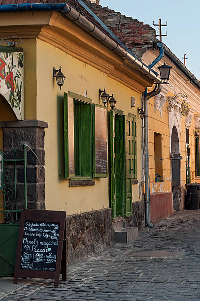 Szentendre, Hungary - March 3rd, 2013: Traditonal old houses and a restaurant's entrance beside a cobblestone street of Szentendre, Hungary.