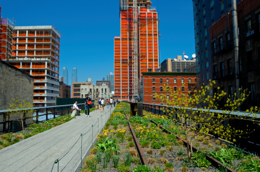 New York City, USA  - April 24, 2013: High Line Park visitors and high rise buildings under construction seen near W.30th Street along the elevated pedestrian walkway, Chelsea, Manhattan.