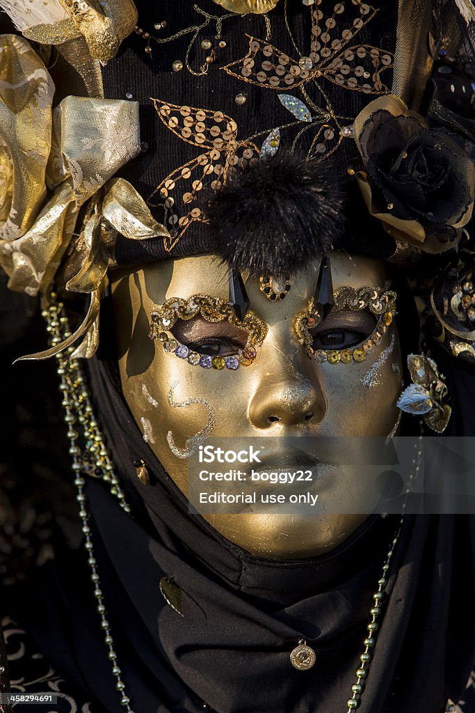 Traditional venetian carnival mask Venice, Italy - February 10, 2013: Unidentified person with traditional Venetian carnival mask in Venice, Italy. At 2013 it is held from January 26th to February 12th. Art And Craft Stock Photo